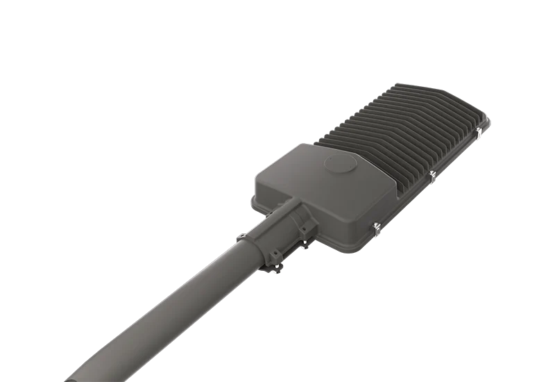 Slim die cast aluminum street light housing with longitudinal finned heat sink and photocell